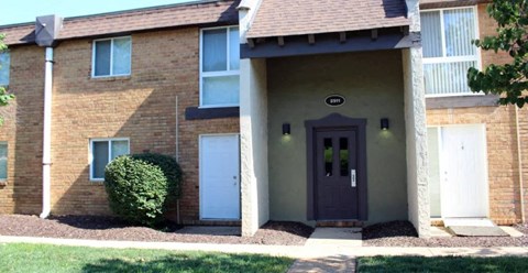 a house with a purple door and a white garage door