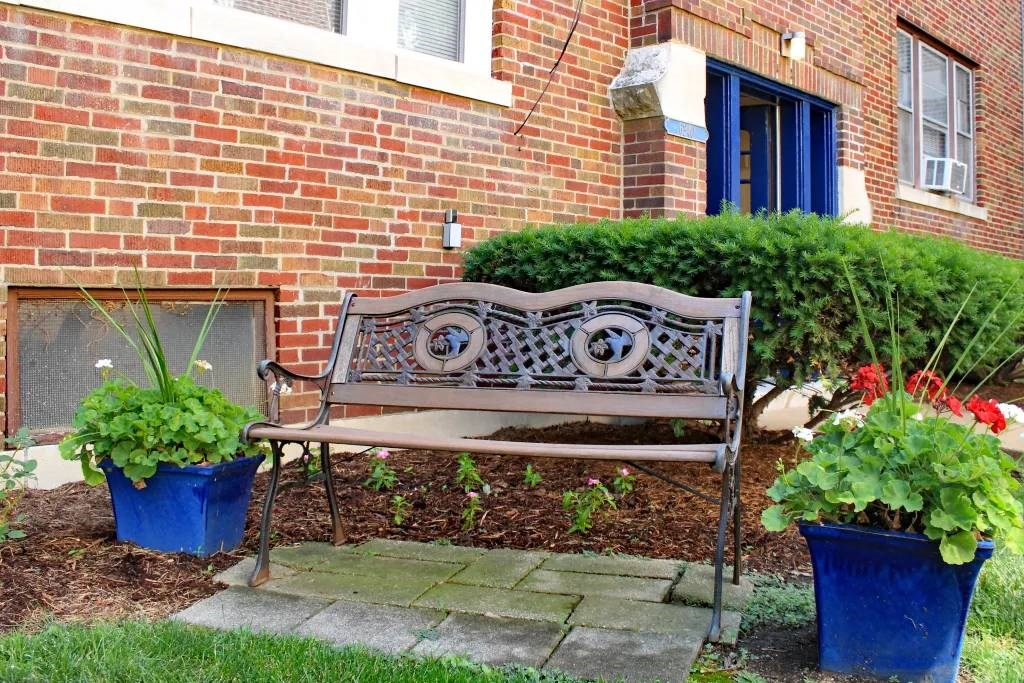 a bench sitting in front of a brick building