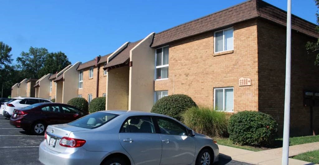 a silver car parked in front of a building