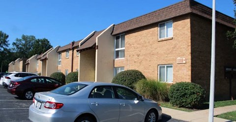 a silver car parked in front of a building