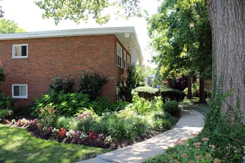 a sidewalk in front of a brick building