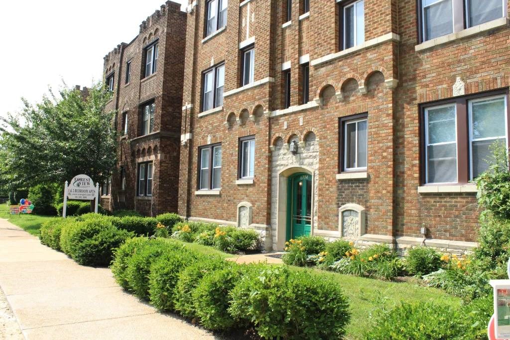 a large brick building with a green door