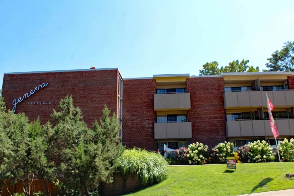 a large brick building with a flag in front of it