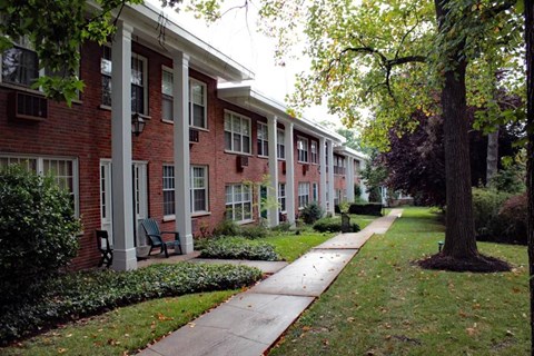 a sidewalk in front of a brick building