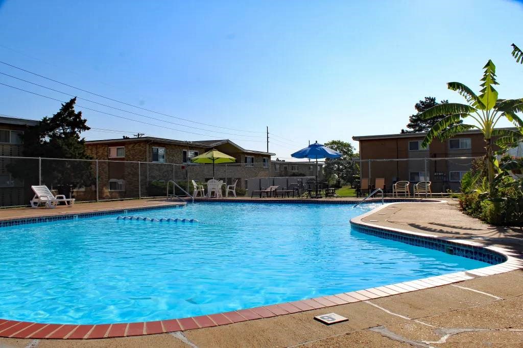 a swimming pool with a blue sky in the background