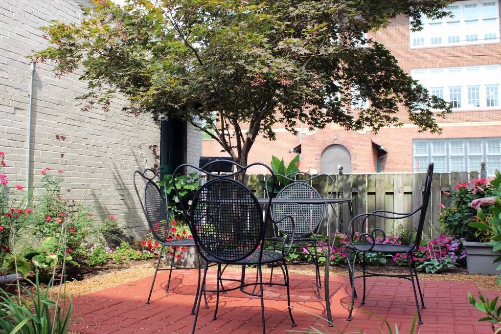 a patio with four chairs and a table