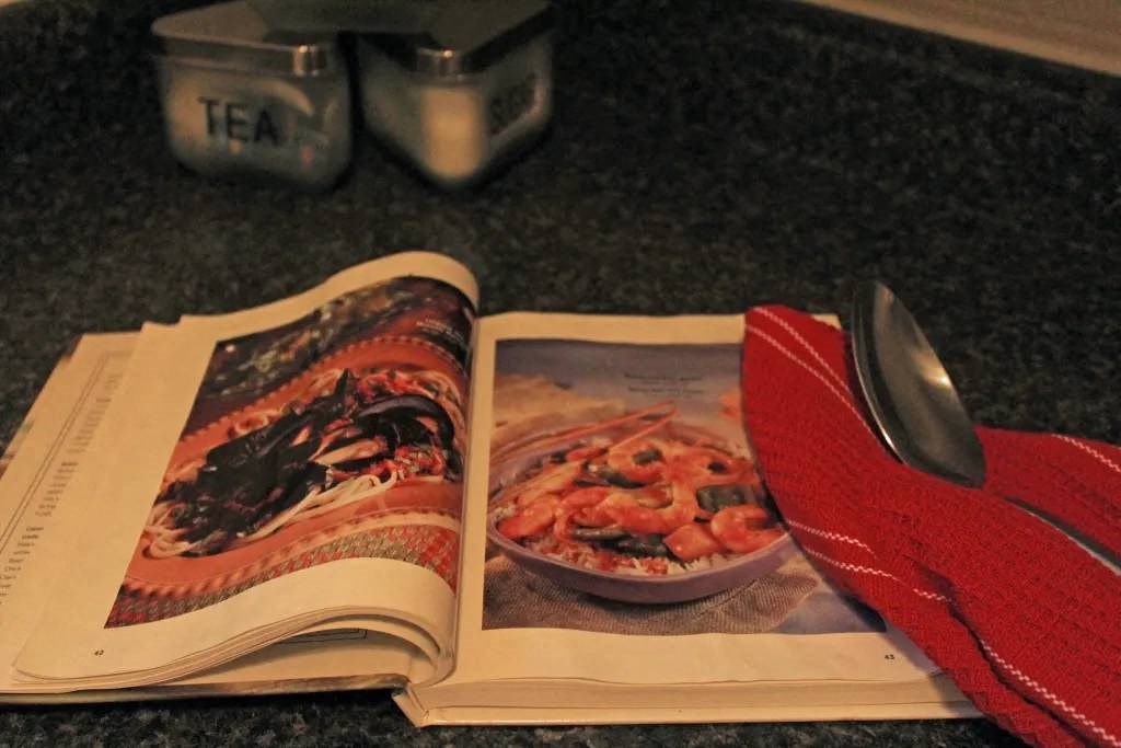 a book on a table with a bowl of food in it