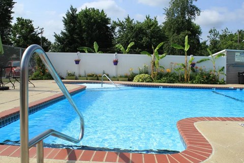 a large pool with a fence in the background
