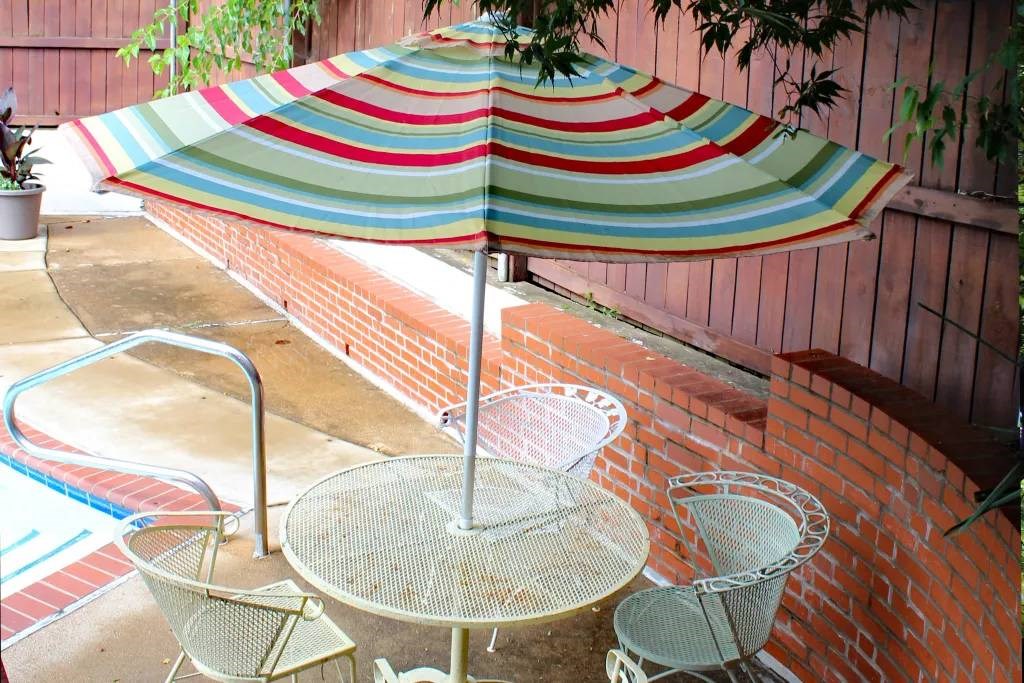 a table and chairs with an umbrella on a patio