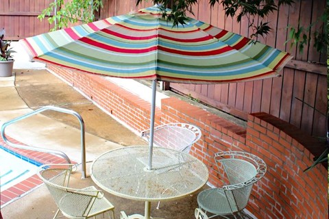 a table and chairs with an umbrella on a patio