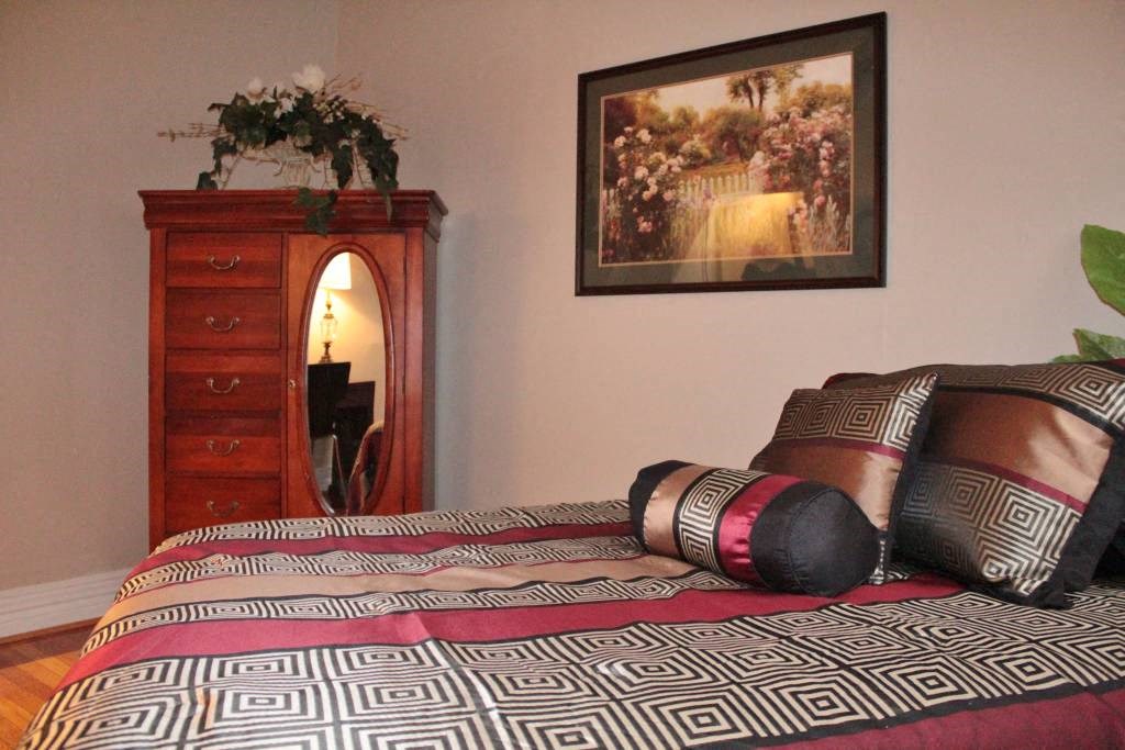 a bedroom with a bed and a dresser