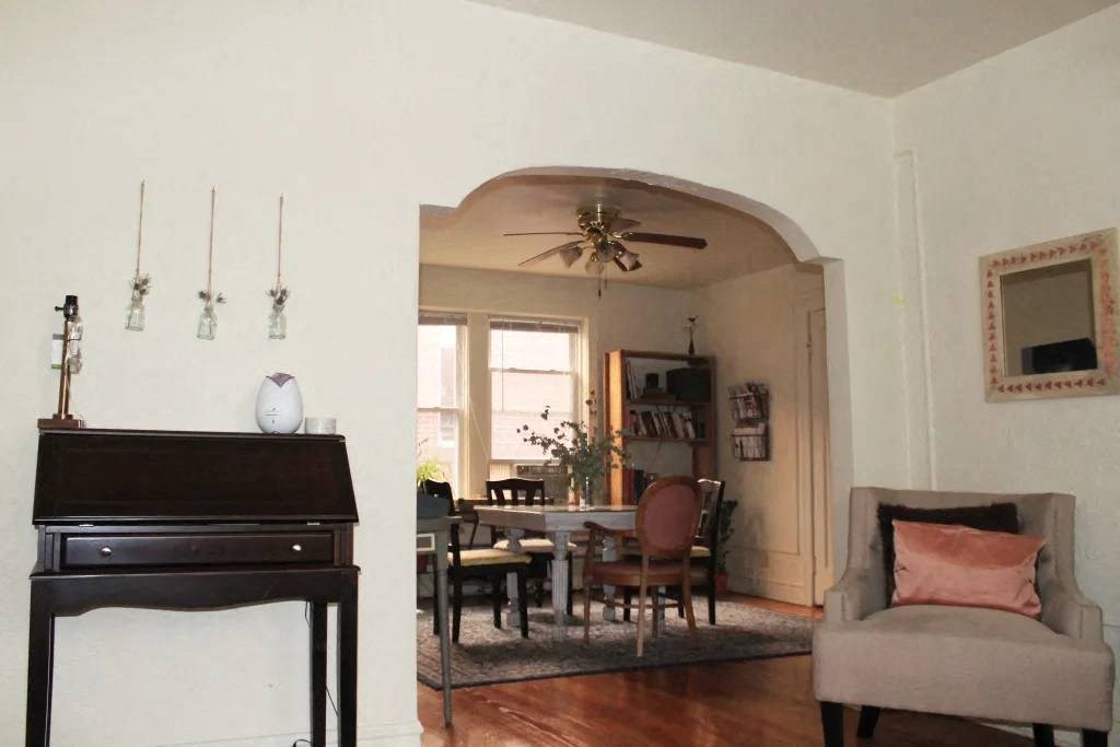 a living room filled with furniture and a ceiling fan
