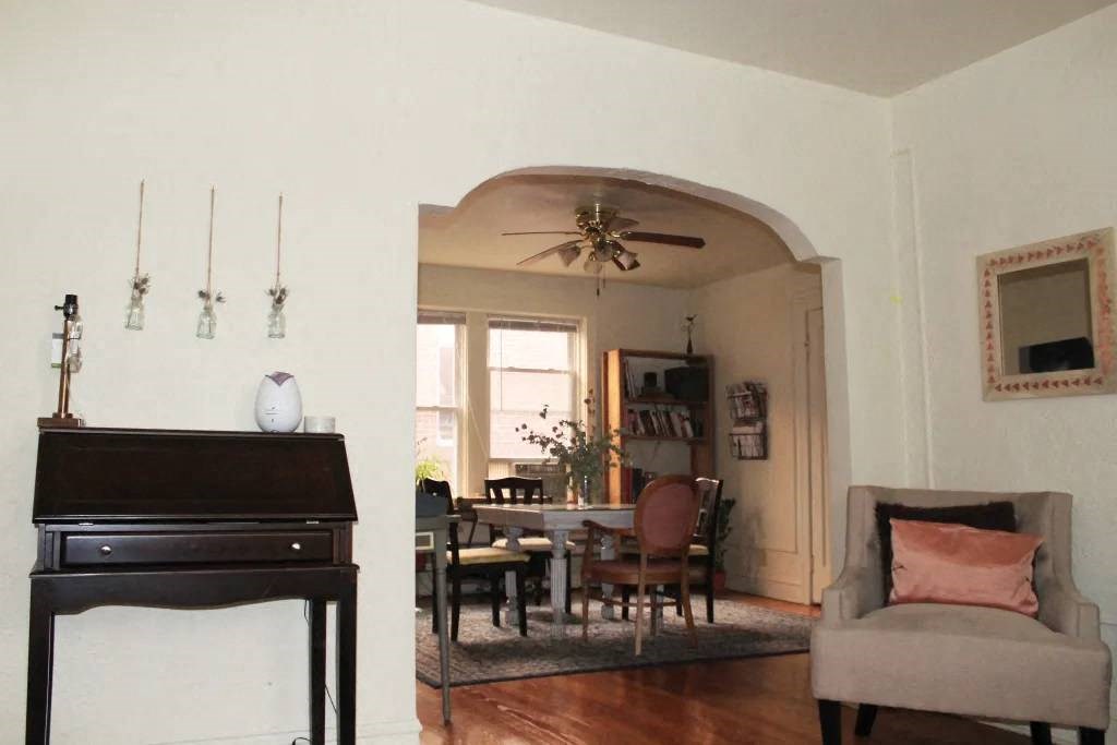 a living room filled with furniture and a ceiling fan