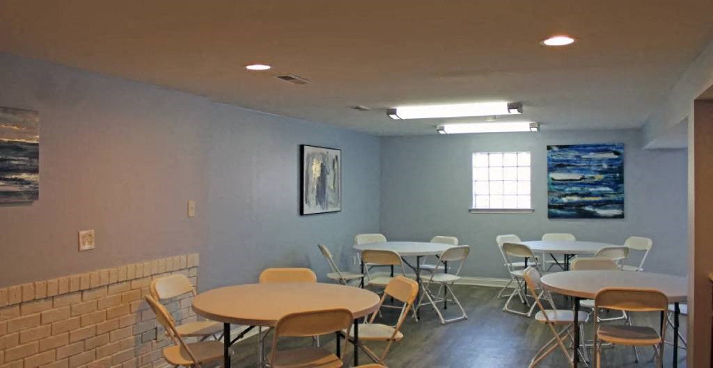 a room with tables and chairs and a window