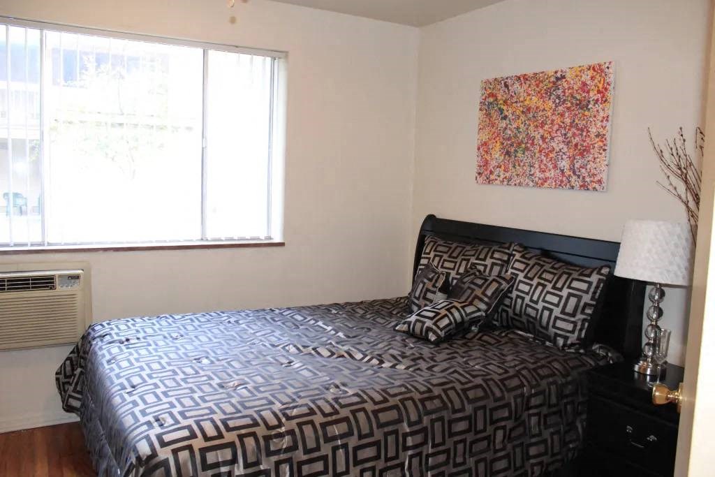 a bedroom with a bed and a window