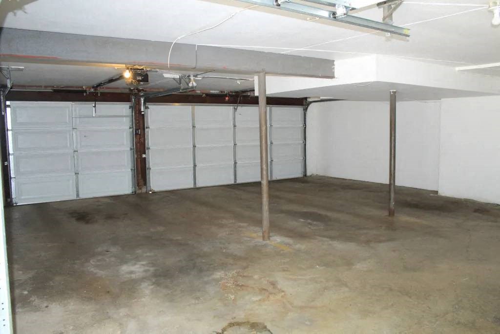 a room with two garage doors and a light on the ceiling
