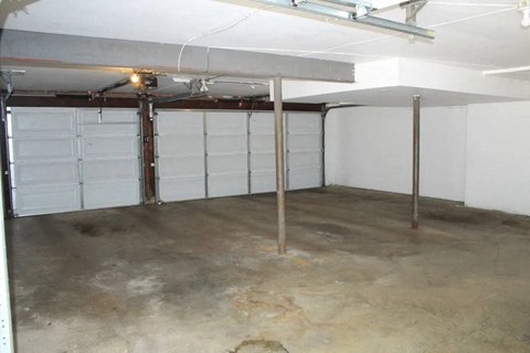 a room with two garage doors and a light on the ceiling