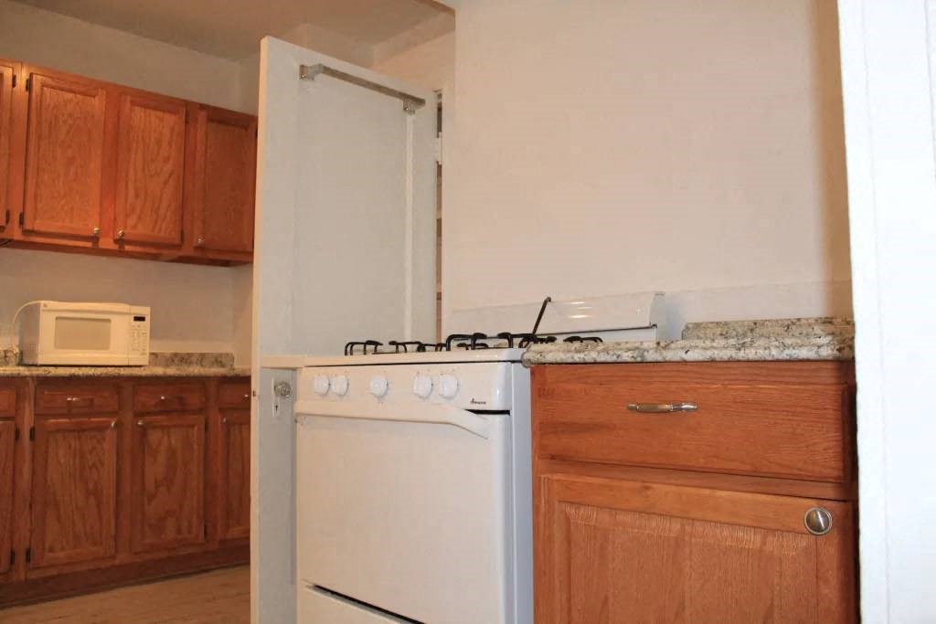 a white stove top oven sitting in a kitchen