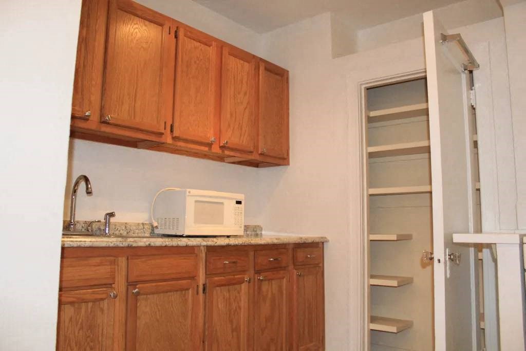 a kitchen with a sink and a microwave
