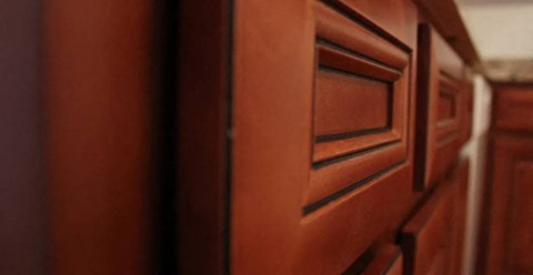 a close up of a wooden cabinet in a room