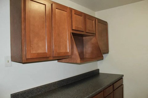 a kitchen with wooden cabinets and a microwave