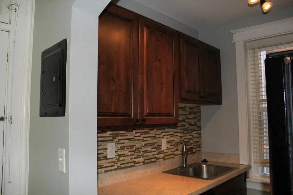 a kitchen with wooden cabinets and a sink