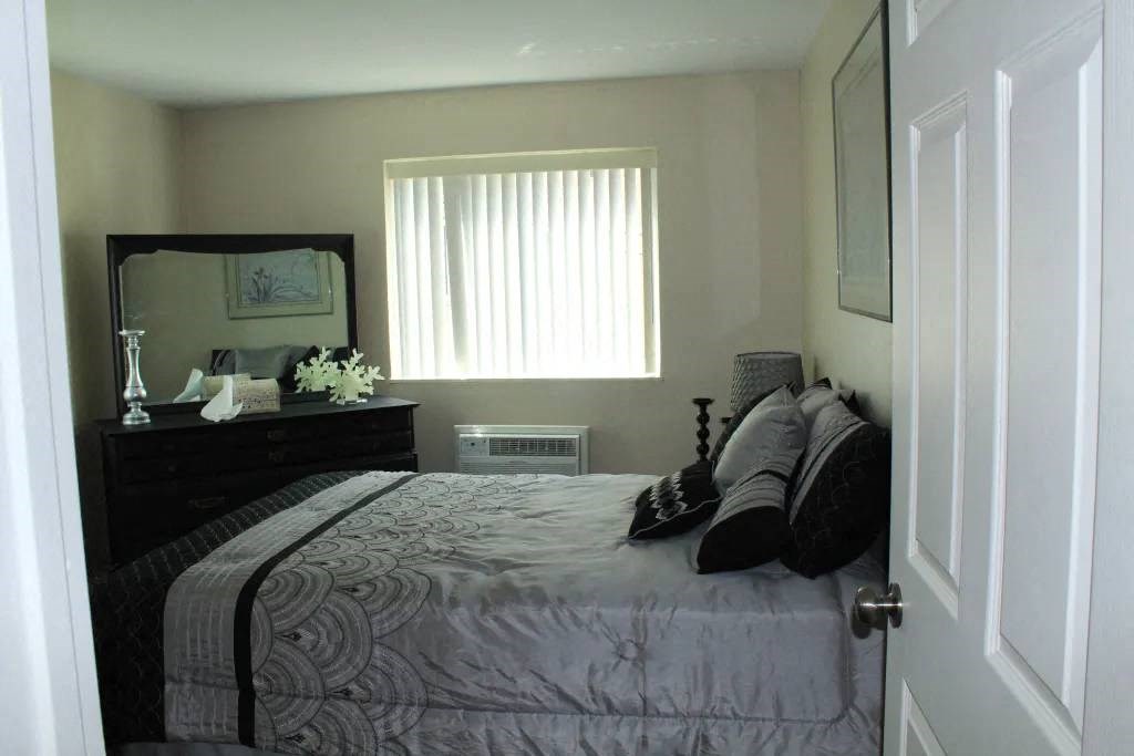 a bedroom with a bed and a dresser in it