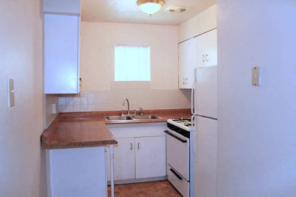 a kitchen with a sink stove and refrigerator