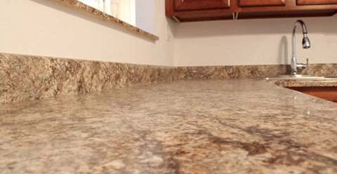 a kitchen with a counter top and a sink