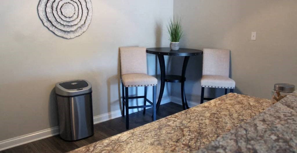 a small table and two chairs in the corner of a room