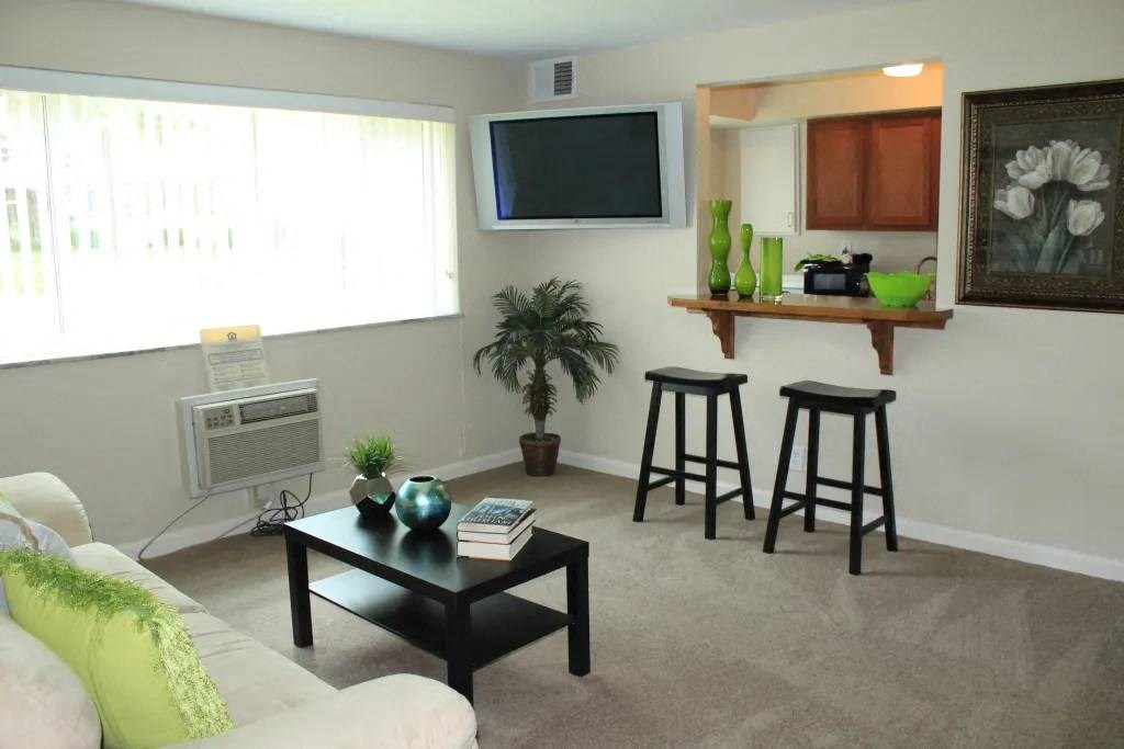 a living room with a couch a table and a television