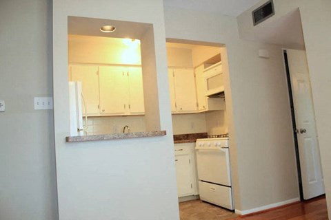 a kitchen with a white stove top oven next to a doorway