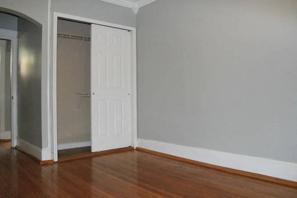 a room with a wooden floor and a white door