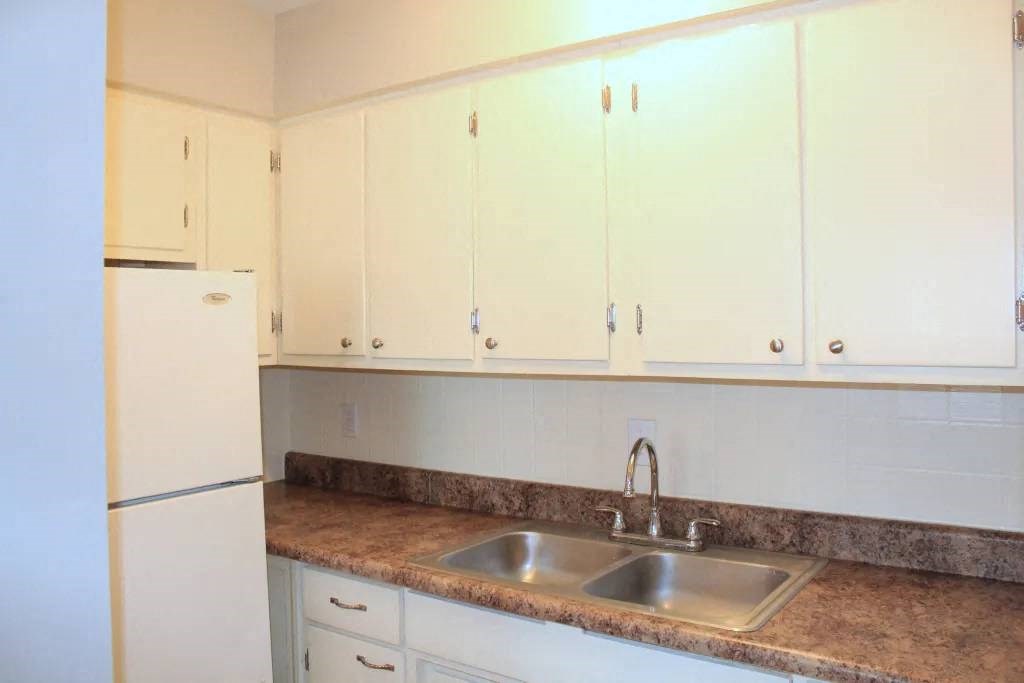 a kitchen with a sink and a refrigerator