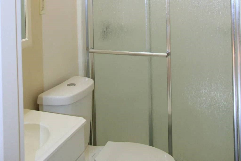 a bathroom with a toilet sink and a shower