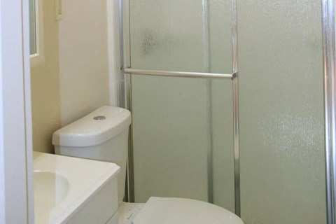 a bathroom with a toilet sink and a shower