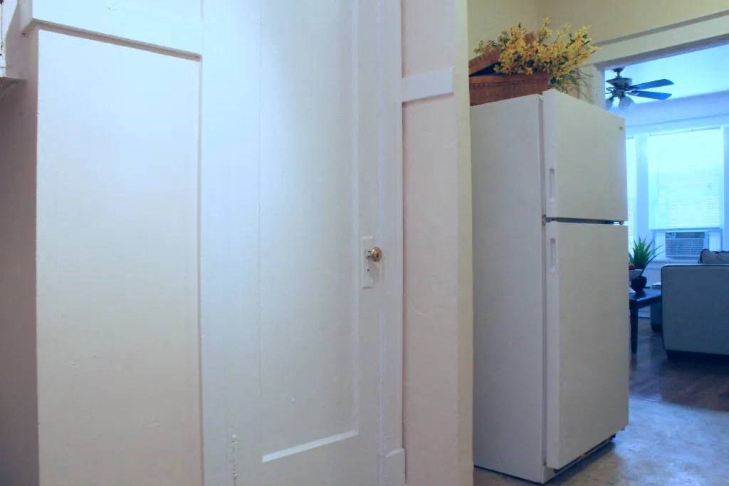 a refrigerator and a door in a room