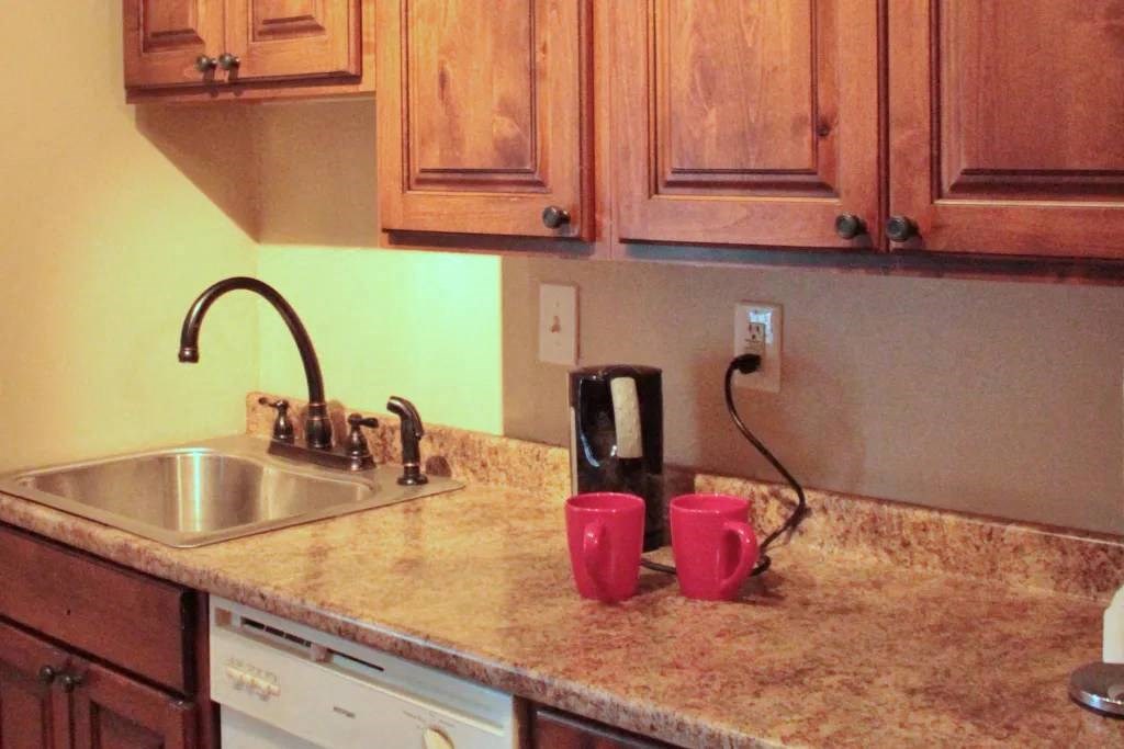 a kitchen with wooden cabinets and a sink