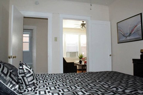 a bedroom with a bed and a window