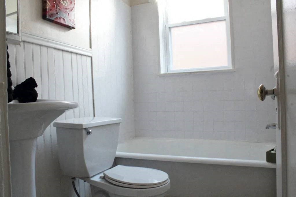 a bathroom with a toilet and a bathtub