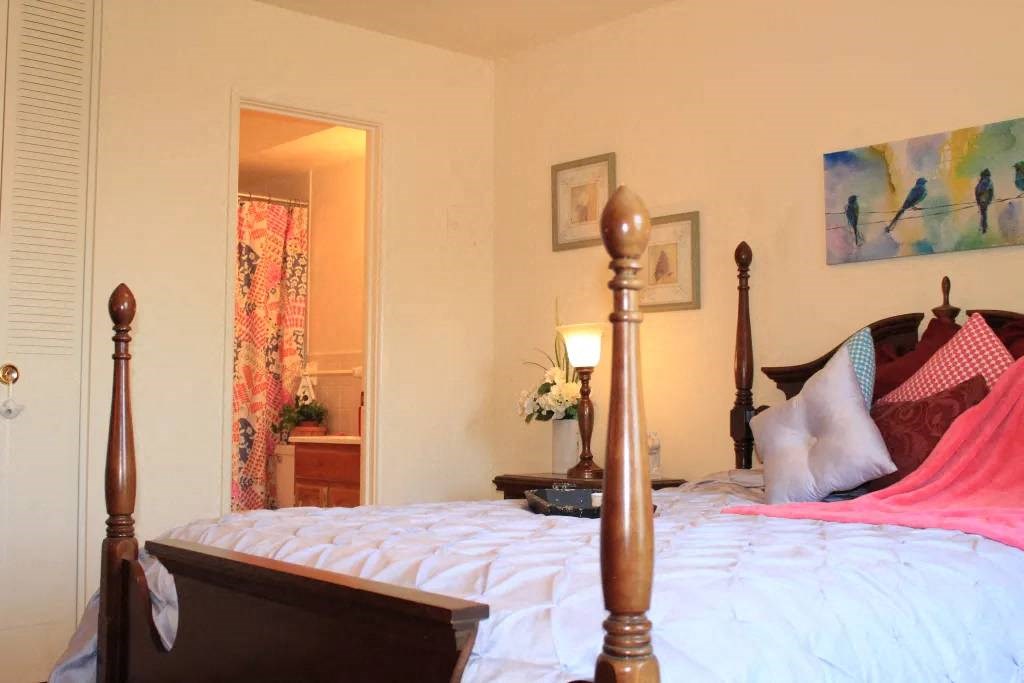 a bedroom with a bed and a door to a bathroom