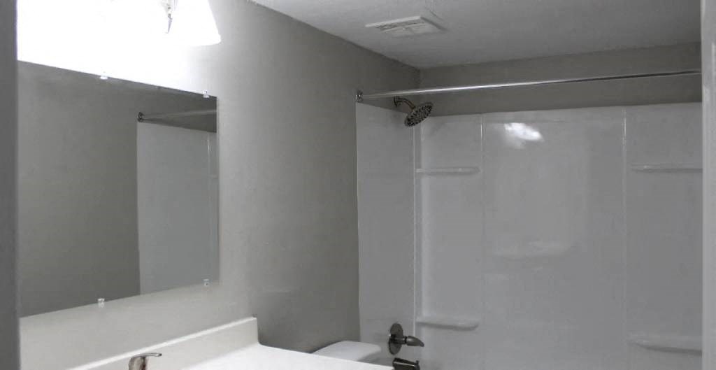 a bathroom with a white sink and a white toilet
