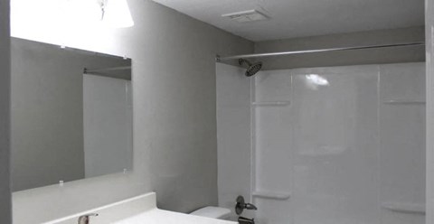 a bathroom with a white sink and a white toilet