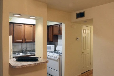 a kitchen with a stove top oven next to a sink