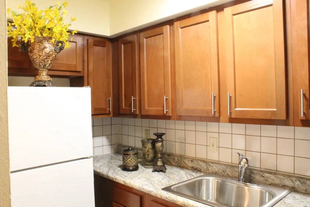 a kitchen with a sink a refrigerator and a microwave