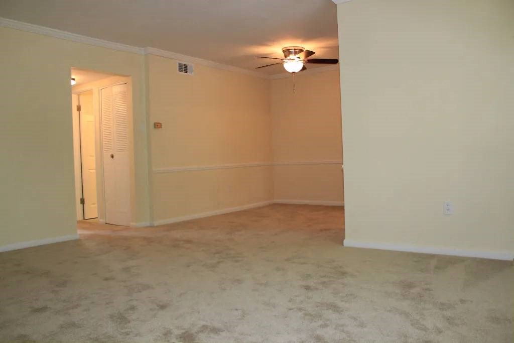 a empty room with a ceiling fan and a light