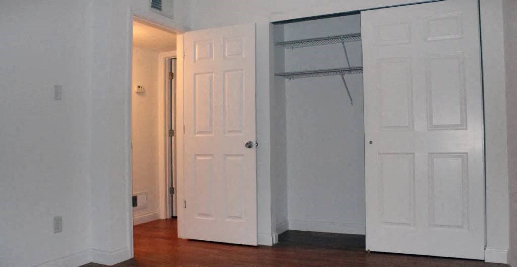 a white door and a white closet in a room