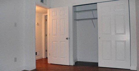 a white door and a white closet in a room