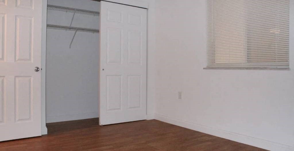 a room with a white door and a window