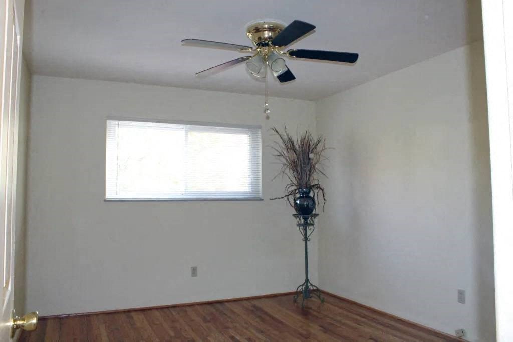 a room with a ceiling fan and a window
